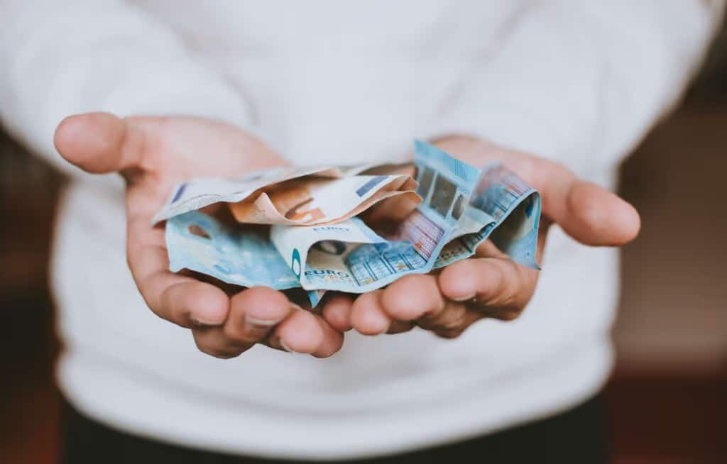 a person holding money in their hands