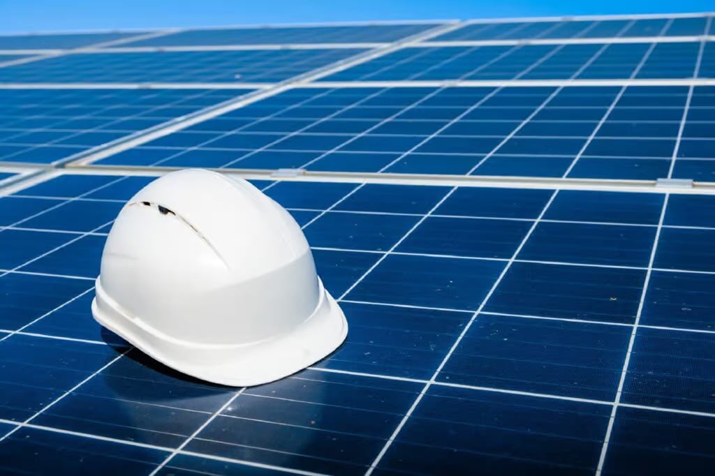 a white hard hat on a solar panel