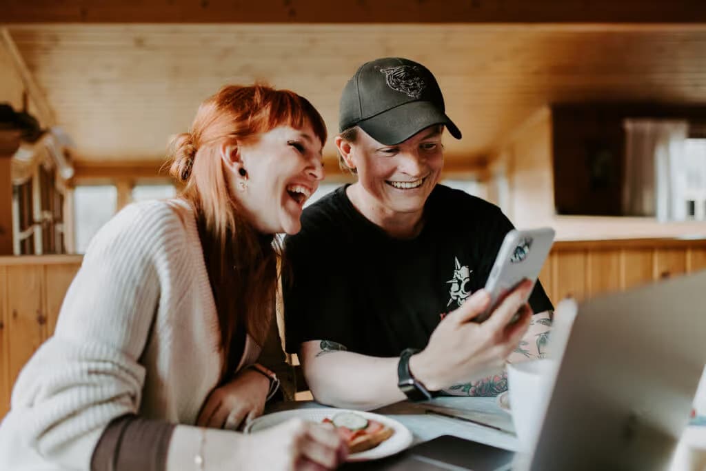 a man and woman looking at a phone