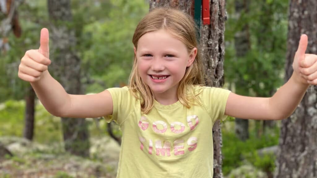 a girl standing in the woods