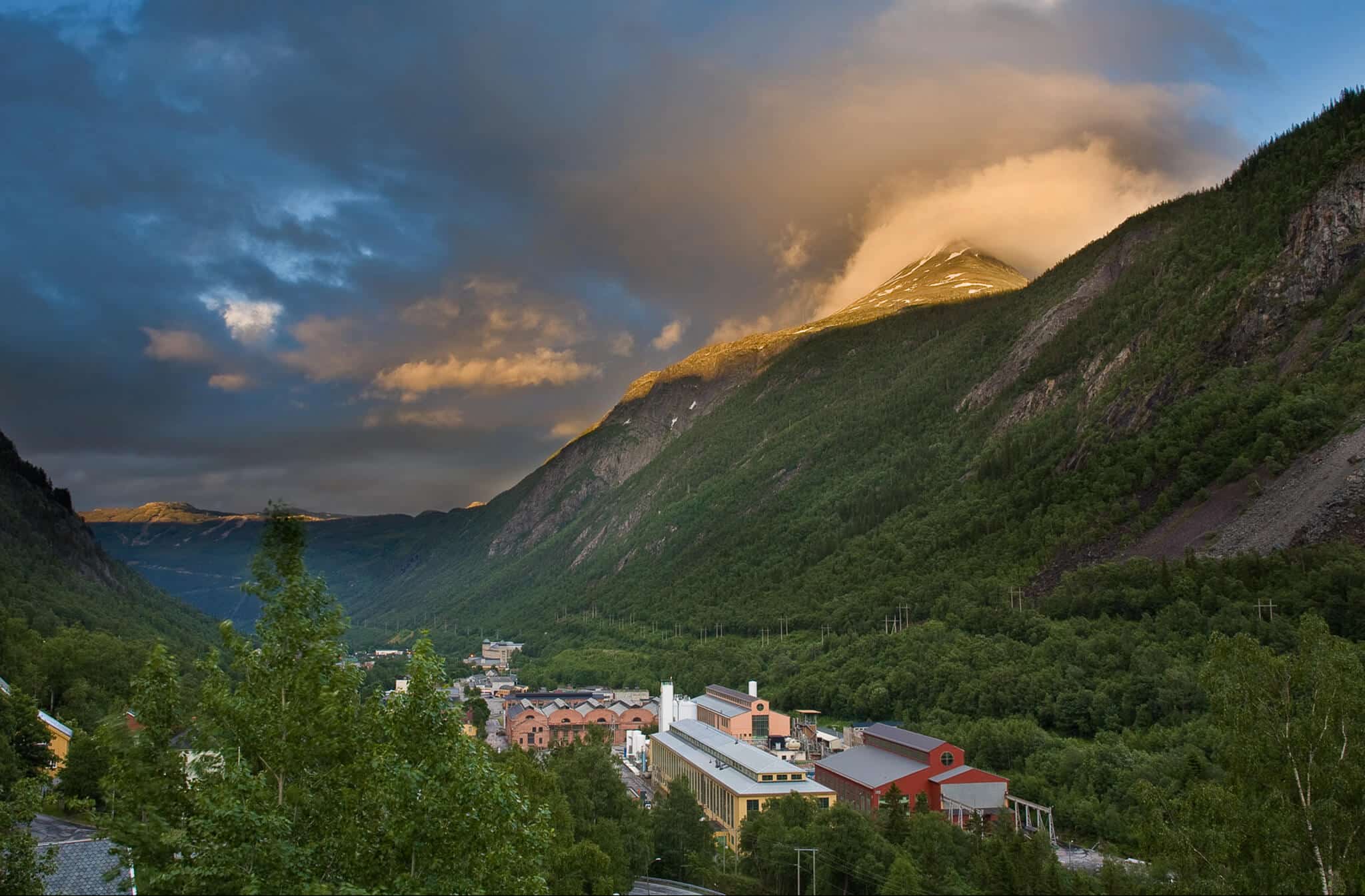 a mountain with trees and buildings